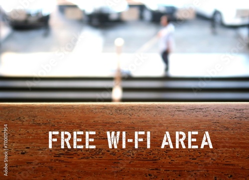 Table with text FREE WIFI, wireless internet facility is available for customers or visitors in business or public places to increase modern lifestyle customer satisfaction to stay connected anywhere