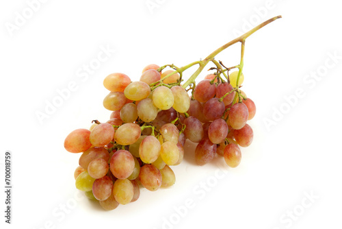 Bunch of organic pink grapes isolated on white background.