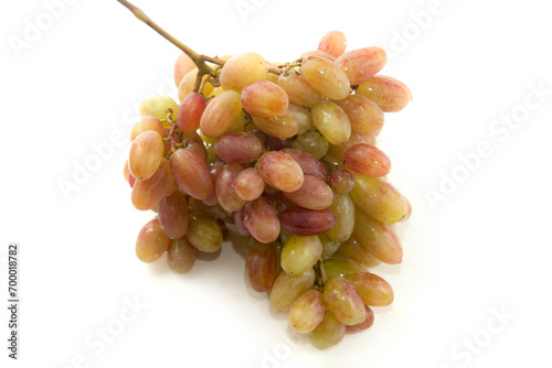Bunch of organic pink grapes isolated on white background.