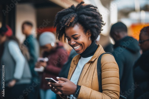 joyful african american girl with phone in public place