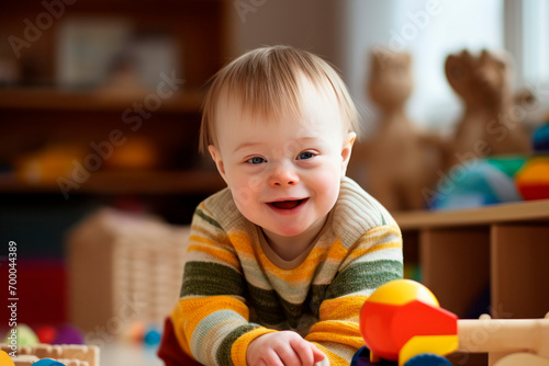 child with down syndrome plays with educational toys and smiles photo