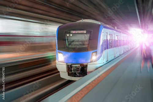 Suburban high speed passenger train arrives at platform station. Around blurry speed effect. The concept of modern comfortable fast passenger transportation in the region photo