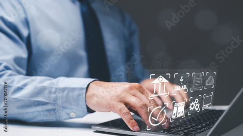 Businessman working concept. Business professional, a man working diligently in office, harnesses internet and online communication tools, utilizing his laptop to manage financial data efficiently.