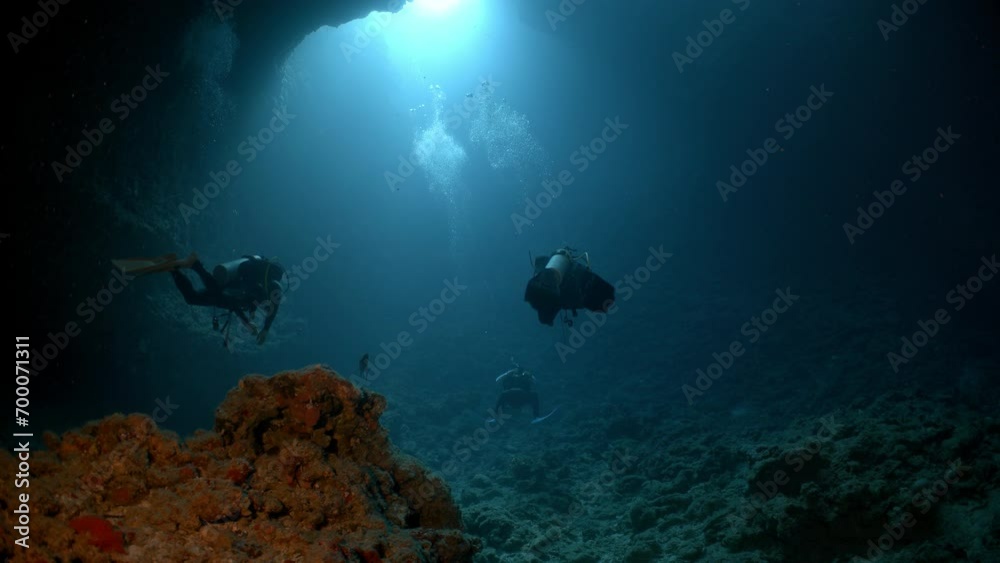 SCUBA Divers explore underwater cave SCUBA Divers explore underwater cave