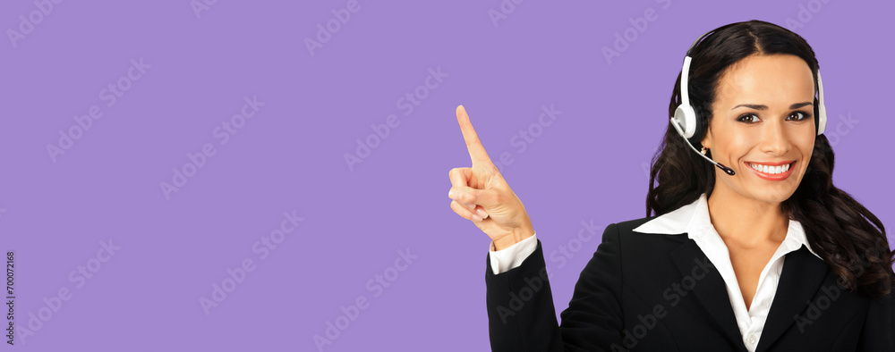 Call center service. Customer support phone sales operator in headset showing something or copy space area for text, imaginary, product or slogan, isolated violet purple background. Call center service. Customer support phone sales operator in headset showing something or copy space area for text, imaginary, product or slogan, isolated violet purple background.