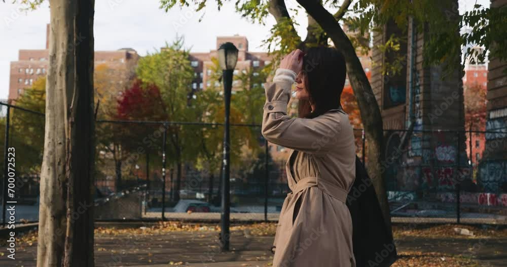 Attractive brunette female walking and enjoying colorful sunny autumn in New York Attractive brunette female walking and enjoying colorful sunny autumn in New York