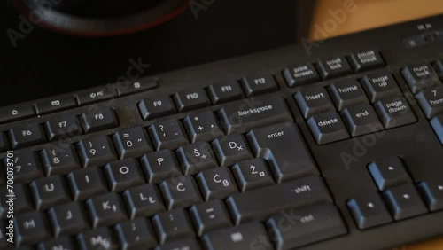 Hand typing Enter key on nonwestern keyboard closeup photo