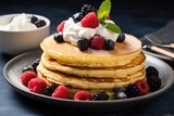 Partially eaten keto pancakes made with coconut or almond flour, topped with berries and whipped cream on a plate.