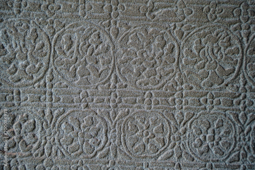 Ancient asian stone wall with flower ornaments in Cambodia Angkor Wat Siem Reap for pattern background 