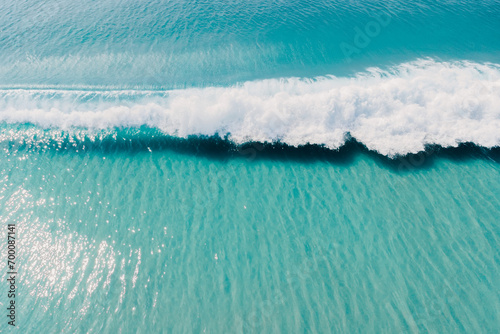 Blue ocean and surfing wave. Surfing waves in tropics. Aerial view photo