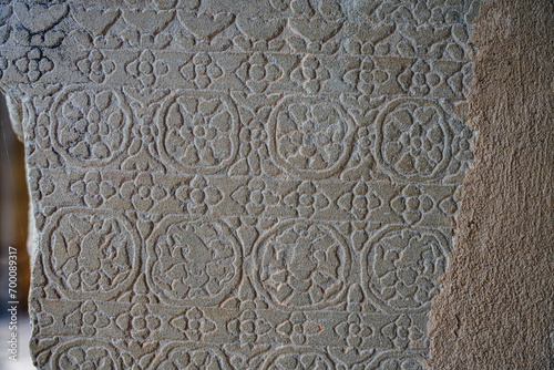 Ancient asian stone wall with flower ornaments in Cambodia Angkor Wat Siem Reap for pattern background 