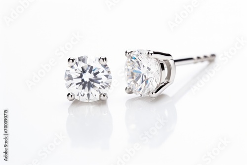 Silver diamond earrings on white background.