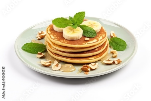 Banana-nut-mint pancakes on a white plate.