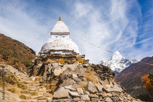 Buddhist stupa and Ama Dablam mountain , Nepal photo