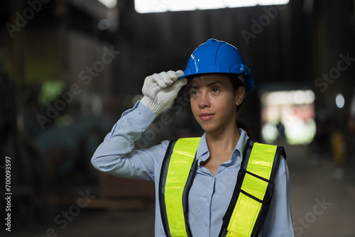 Close up of female factory worker working in industry factory area. Worker and manufacturing industry factory concept