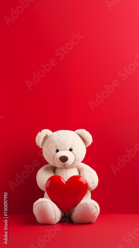 brown teddy bear holding a red heart