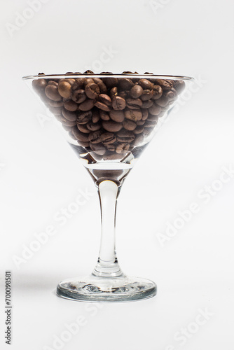 Coffee beans in a glass glass on a white background, coffee beans in a mug