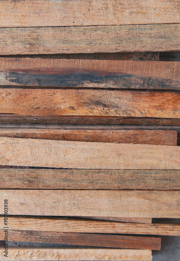 Naklejka premium stained brown wooden planks stacked horizontally