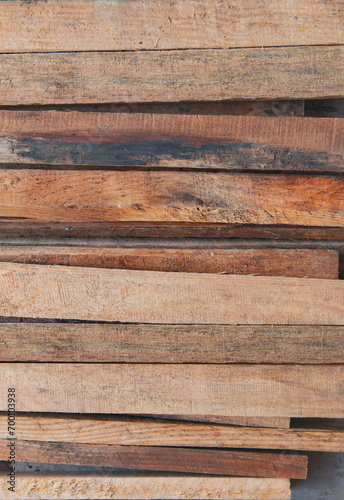 Fototapeta Naklejka Na Ścianę i Meble -  stained brown wooden planks stacked horizontally