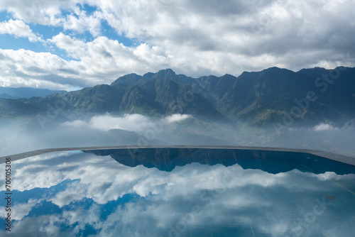 Mountain with clouds sky reflection with water in infinity pool in Sa Pa, Vietnam