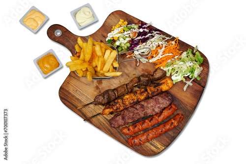 Wooden board with brochette and merguez isolated on white background photo