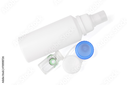 Color contact lenses and bottles of cosmetic product isolated on white, top view