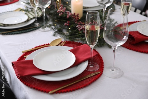 Christmas table setting with festive decor and dishware