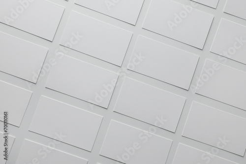 Blank business cards on white background, flat lay. Mockup for design