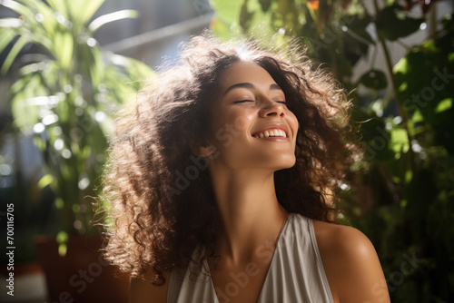 A latin woman breathes calmly looking up enjoying summer season