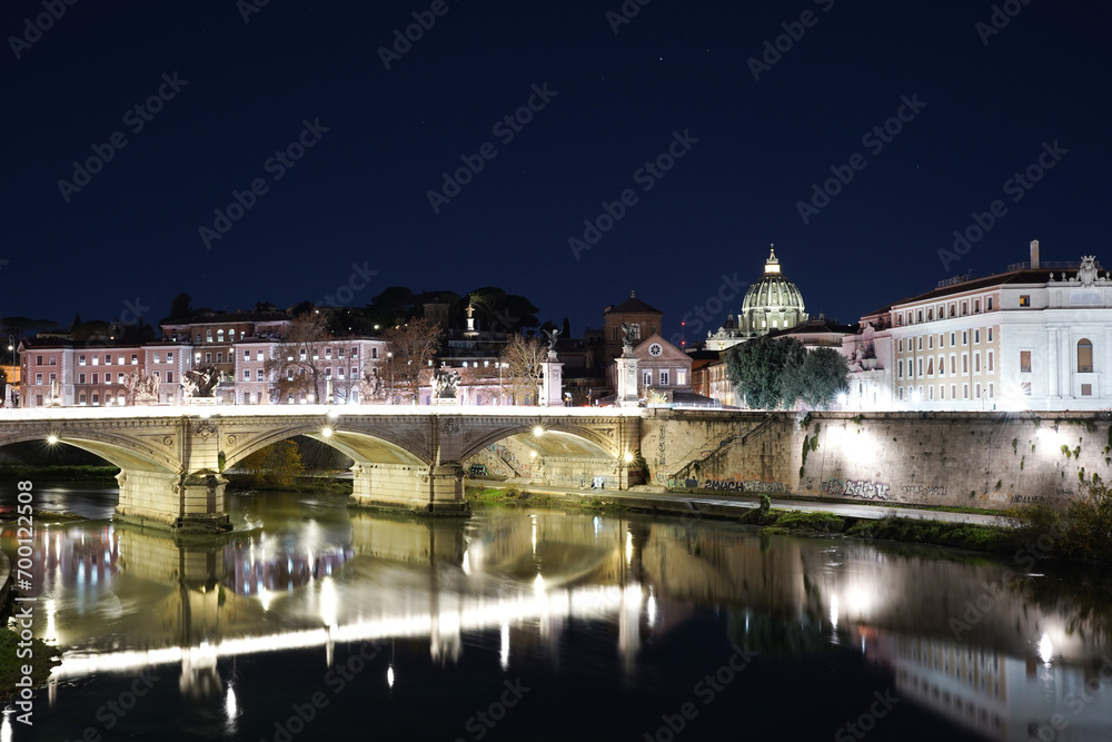 Night view of river bridge and Vatican city with lights and dark blue sky. No people. Calmness 