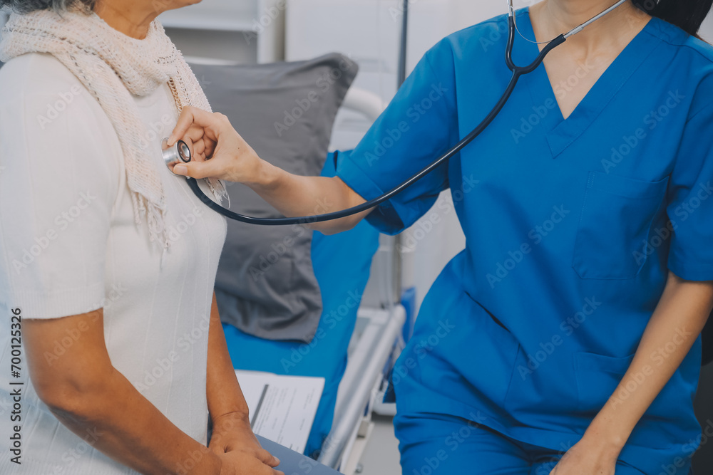 Close up of Female Doctor using stethoscope putting beat heart diagnose with patient in examination room at a hospital, check-up body, Medical and Health Care Concept. Close up of Female Doctor using stethoscope putting beat heart diagnose with patient in examination room at a hospital, check-up body, Medical and Health Care Concept.
