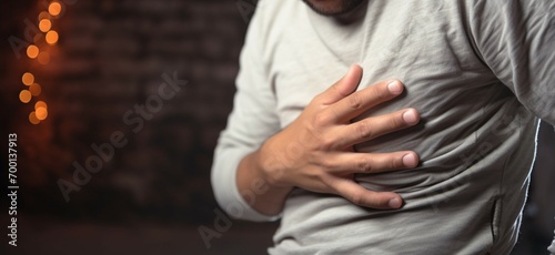Discomfort captured close up of a young man suffering stomach pain photo