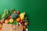 Shopping or delivery healthy food background. Healthy vegan vegetarian food in paper bag vegetables and fruits on green, copy space. Food supermarket and clean vegan eating concept. generative ai.