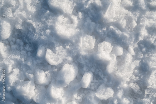 Background with texture of white snow on a snowdrift on a cold winter day