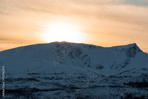 Golden suunseet behind a Norweegian mountain during winter