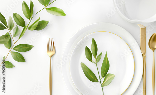 Festive wedding, birthday or christmas table setting with golden cutlery, porcelain plate and green eucalyptus plant. Top view