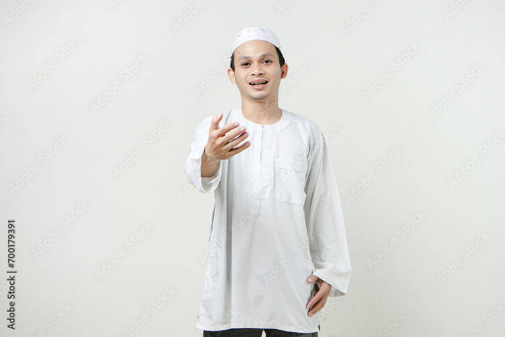 happy asian muslim man offering handshake gesture. People religious Islam lifestyle concept. celebration Ramadan and ied Mubarak. on isolated background. happy asian muslim man offering handshake gesture. People religious Islam lifestyle concept. celebration Ramadan and ied Mubarak. on isolated background.