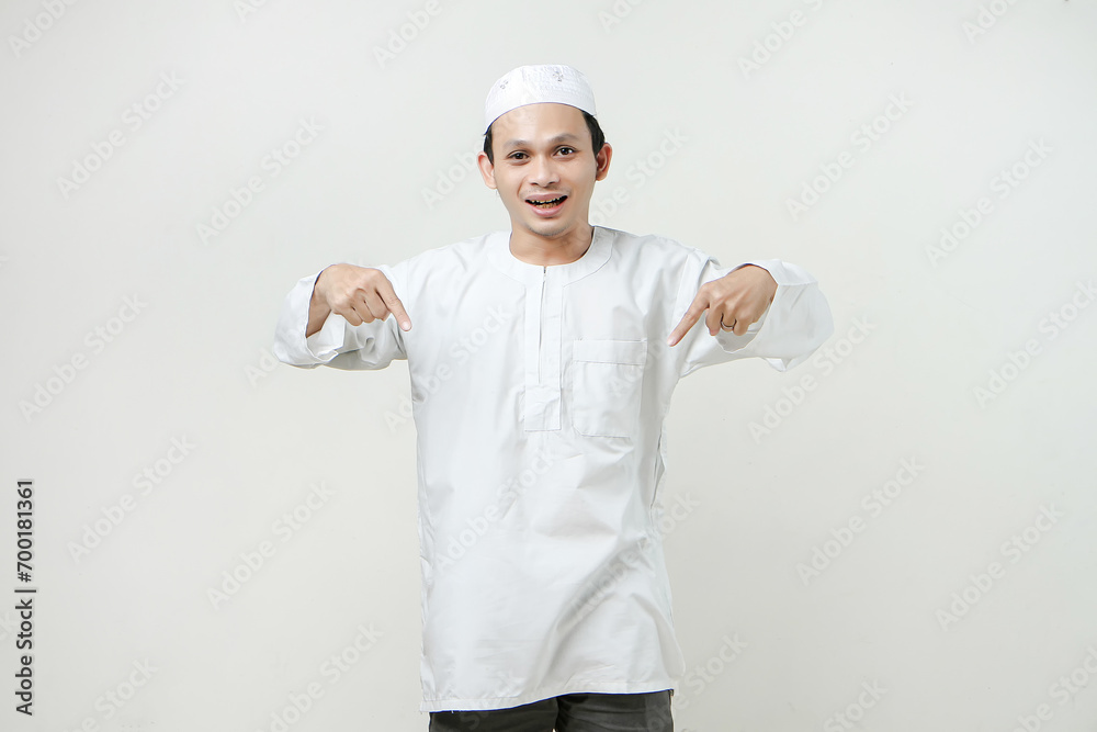 happy asian muslim man give ponting finger gesture. People religious Islam lifestyle concept. celebration Ramadan and ied Mubarak. on isolated background. happy asian muslim man give ponting finger gesture. People religious Islam lifestyle concept. celebration Ramadan and ied Mubarak. on isolated background.