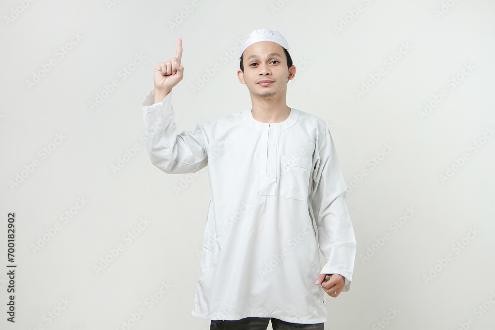 happy asian muslim man give ponting finger gesture. People religious Islam lifestyle concept. celebration Ramadan and ied Mubarak. on isolated background. happy asian muslim man give ponting finger gesture. People religious Islam lifestyle concept. celebration Ramadan and ied Mubarak. on isolated background.