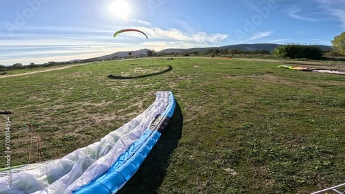 Powered paragliding- paramotor take off with powered paraglider two-stroke engine and paragliding wing froma  field airplane photo