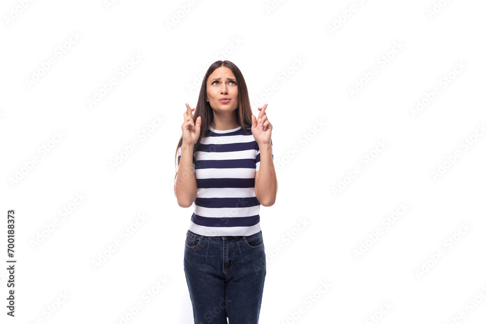young slender European woman with black straight hair wearing a striped black and white T-shirt announces the news using gestures young slender European woman with black straight hair wearing a striped black and white T-shirt announces the news using gestures