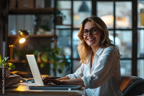 potrait of a Smiling business european woman executive sitting at desk using laptop, 