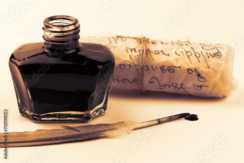 Inkwell and feather quill pen isolated on a white background. Glass bottle with mascara. Black liquid in a glass bottle. Parchment scroll isolated. Ancient paper scroll isolated on a white background.