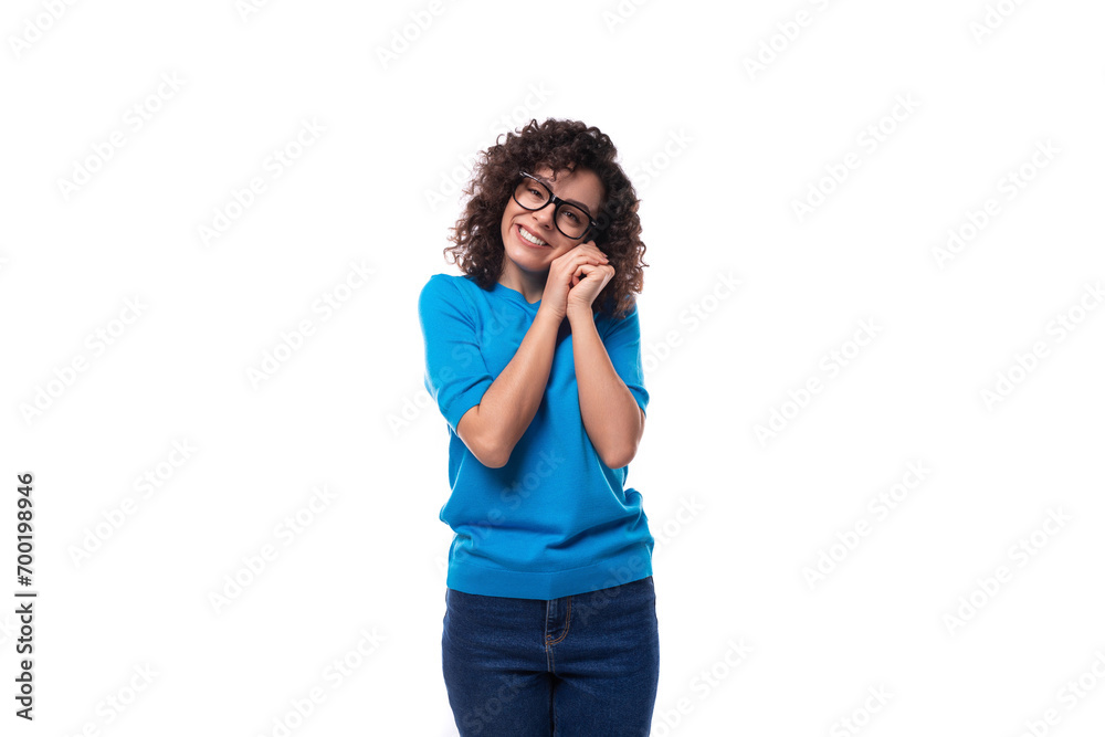 corporate clothing concept. young slender curly woman with black hair dressed in a blue t-shirt with mockup corporate clothing concept. young slender curly woman with black hair dressed in a blue t-shirt with mockup