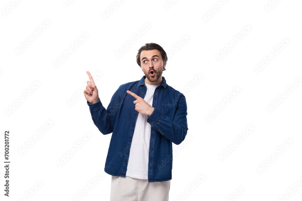 portrait of a young european brutal brunette man with a cool hairstyle pointing his index finger portrait of a young european brutal brunette man with a cool hairstyle pointing his index finger