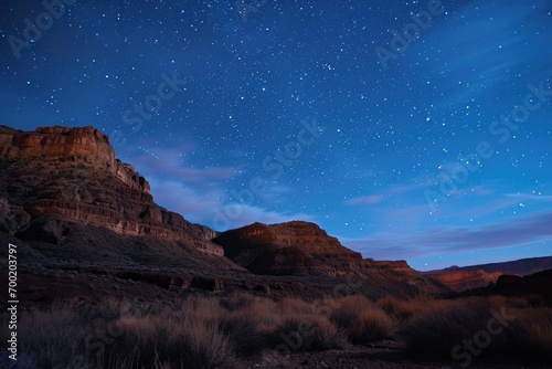 Starry night sky over a tranquil desert landscape.