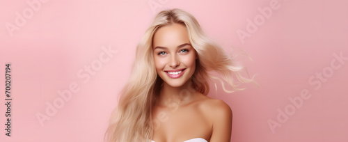 portrait of a  blonde beautiful woman on a pink background abstract