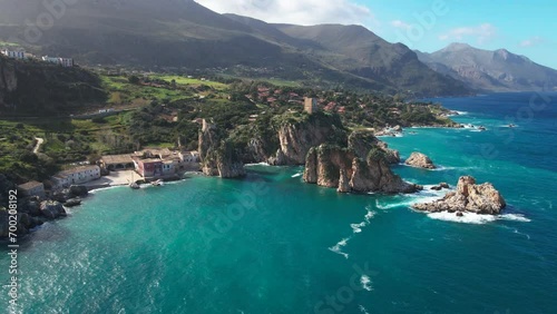 Late afternoon aerial footage of Faraglioni di Scopello in Sicily, Italy photo