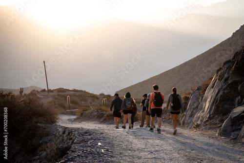 Grupo de amigos haciendo senderismo por caminos montañosos de Tilcara, Jujuy photo