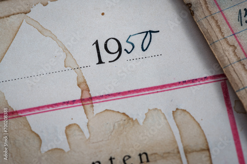 Closeup of vintage grungy, ledger paper with handwriting in ink and coffee stains.  photo